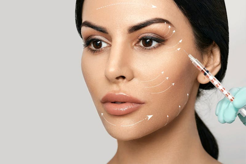 A woman getting an injection in her cheek