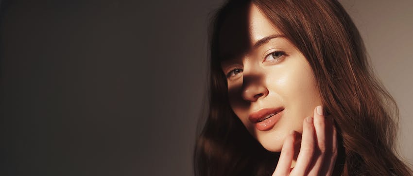 A woman touching her face