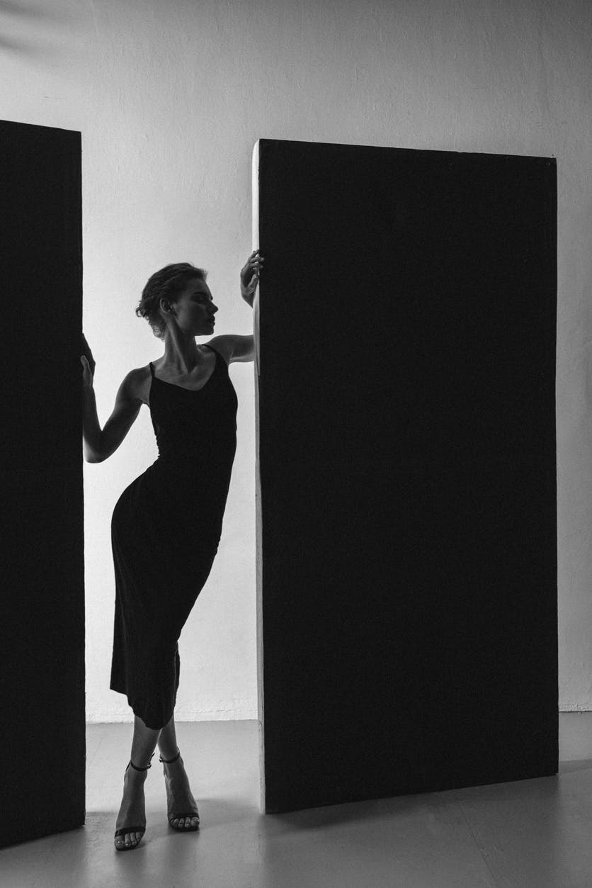 A woman in a tight black dress posing