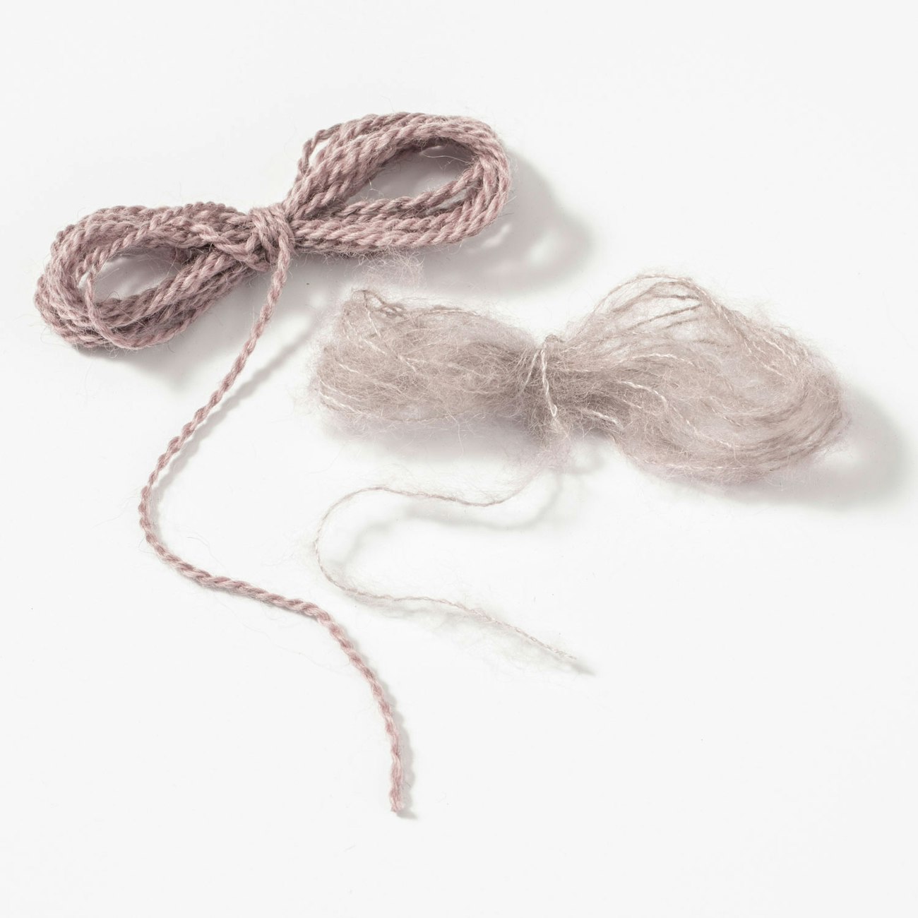 Two mauve yarns, one smooth and one fuzzy