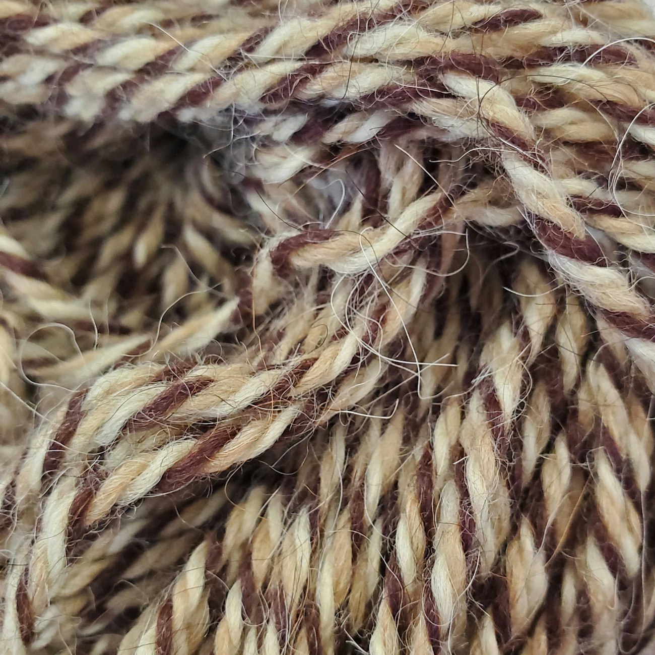 3-ply yarn in white, brown, and tan, with guard hairs