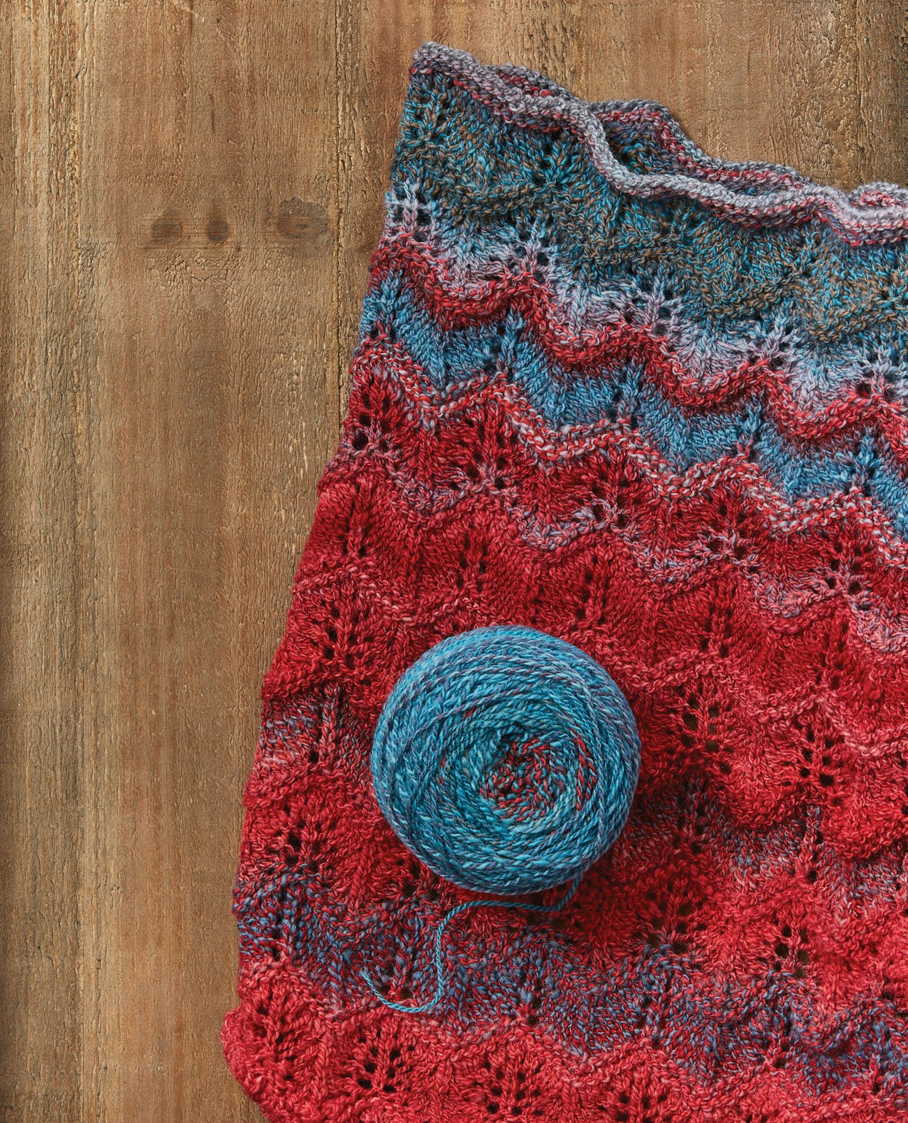 Red and blue handknitted lace cowl with blue handspun yarn