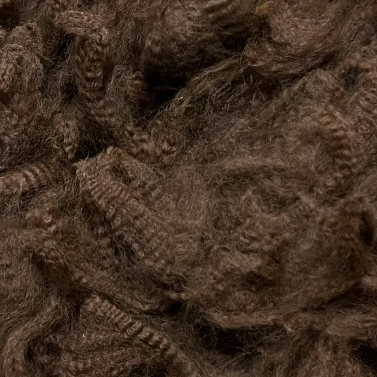 Dark brown alpaca fleece, close-up.