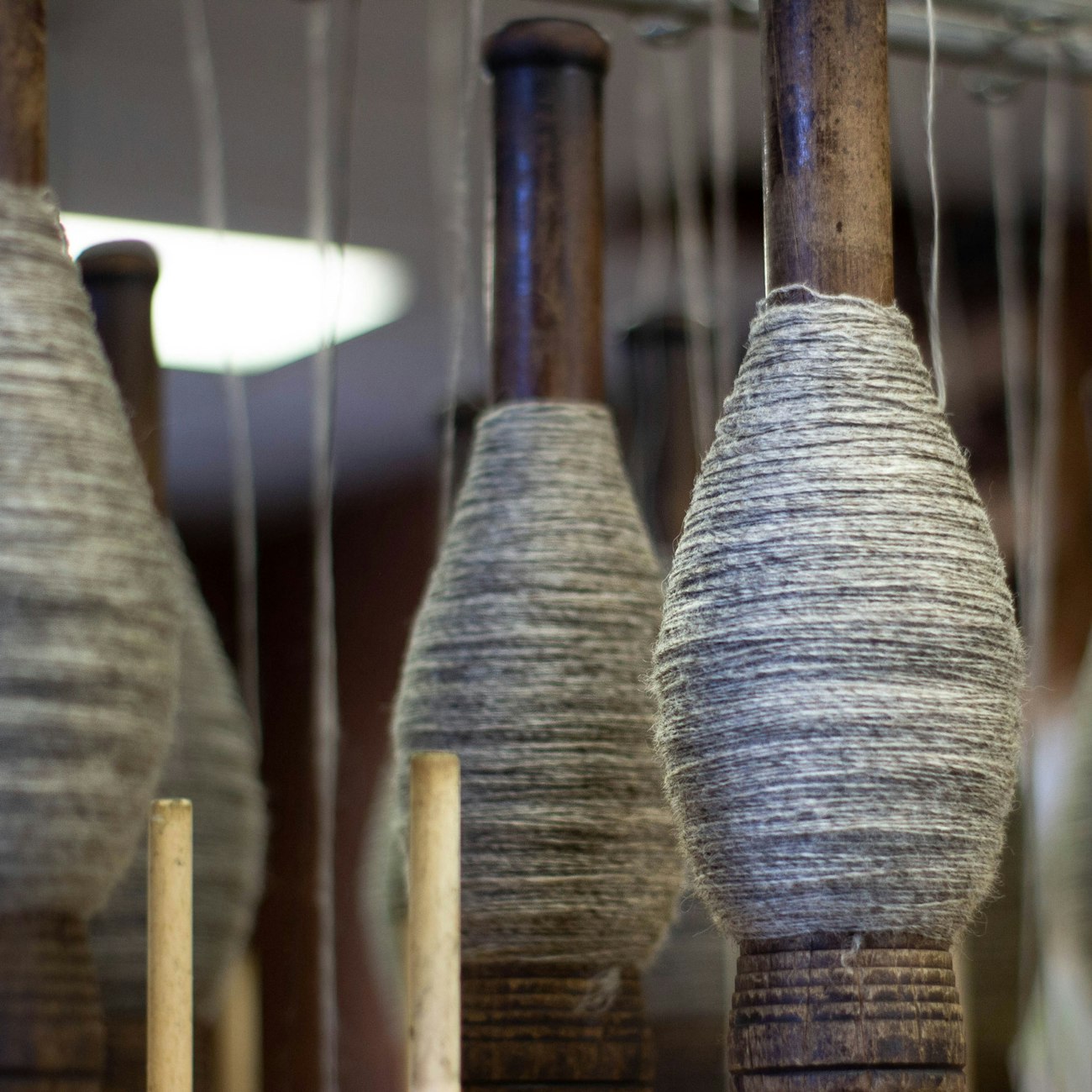 Gray yarn singles on bobbins