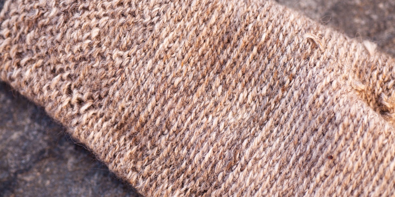 Inside of a brown mitten created with two-end knitting