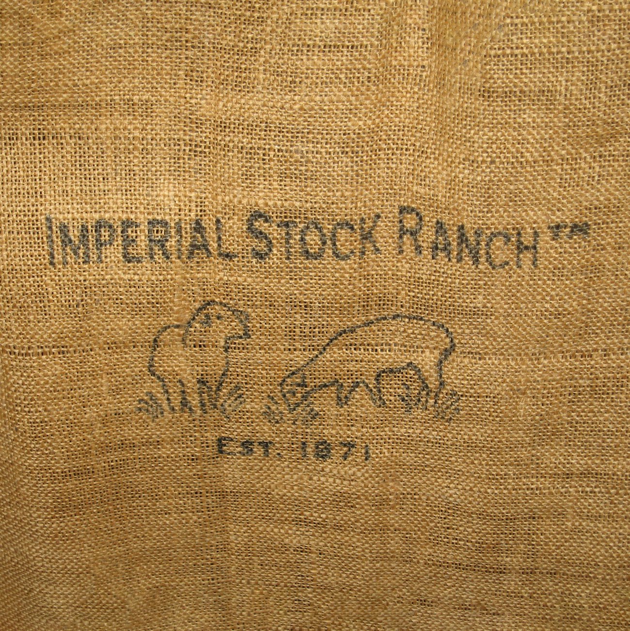 Burlap sack with "Imperial Stock Ranch Est. 1871" and two sheep printed on it