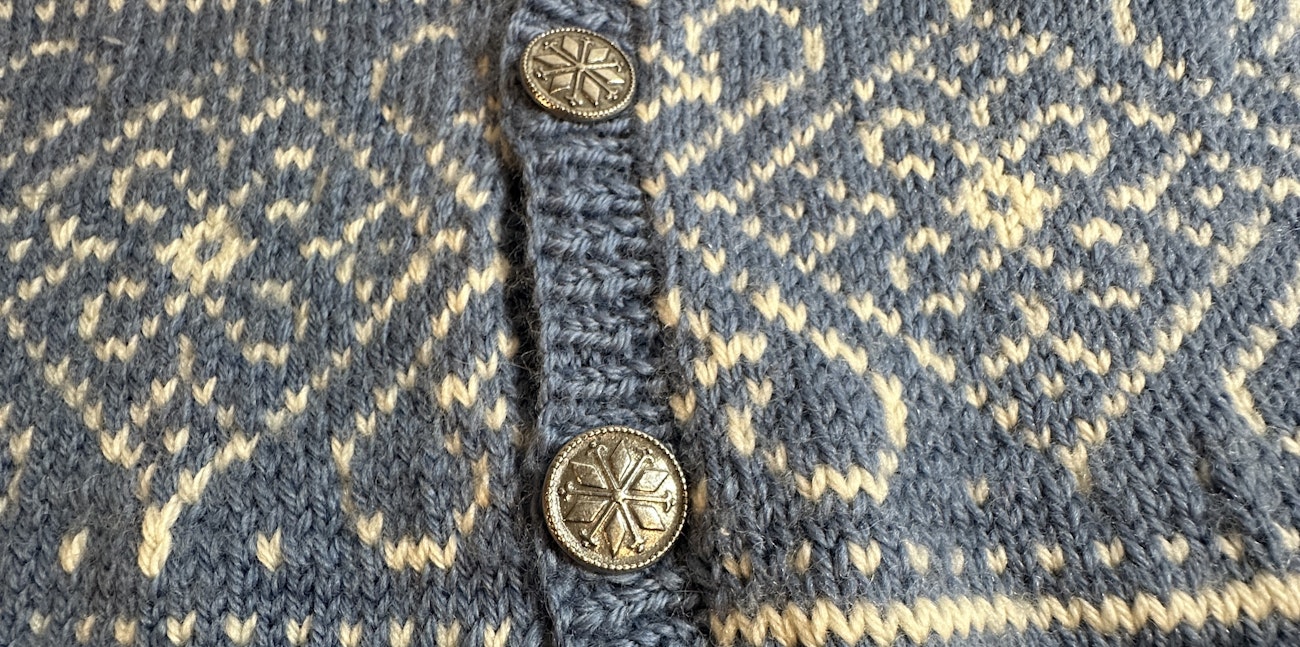 Pewter buttons on blue and white cardigan