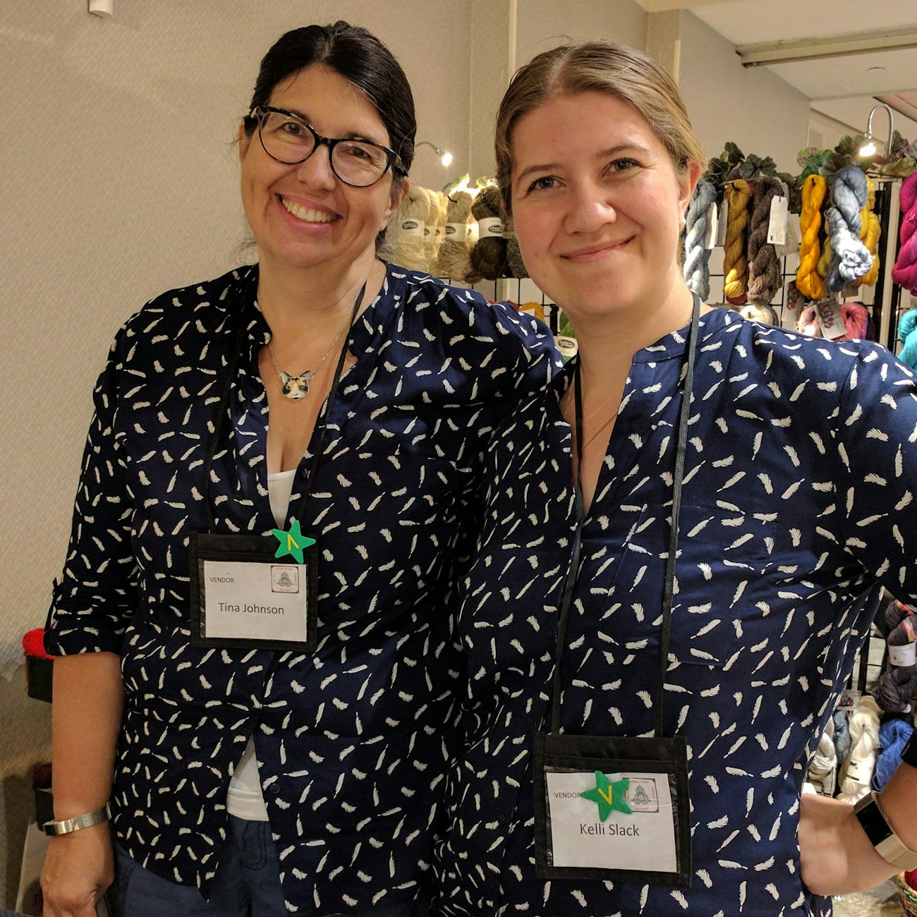 Two women in navy blue shirts wearing name tags that read Tina Johnson and Kelli Slack