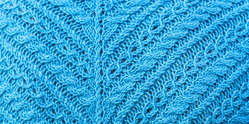 Blue-green cable-covered knitted fabric