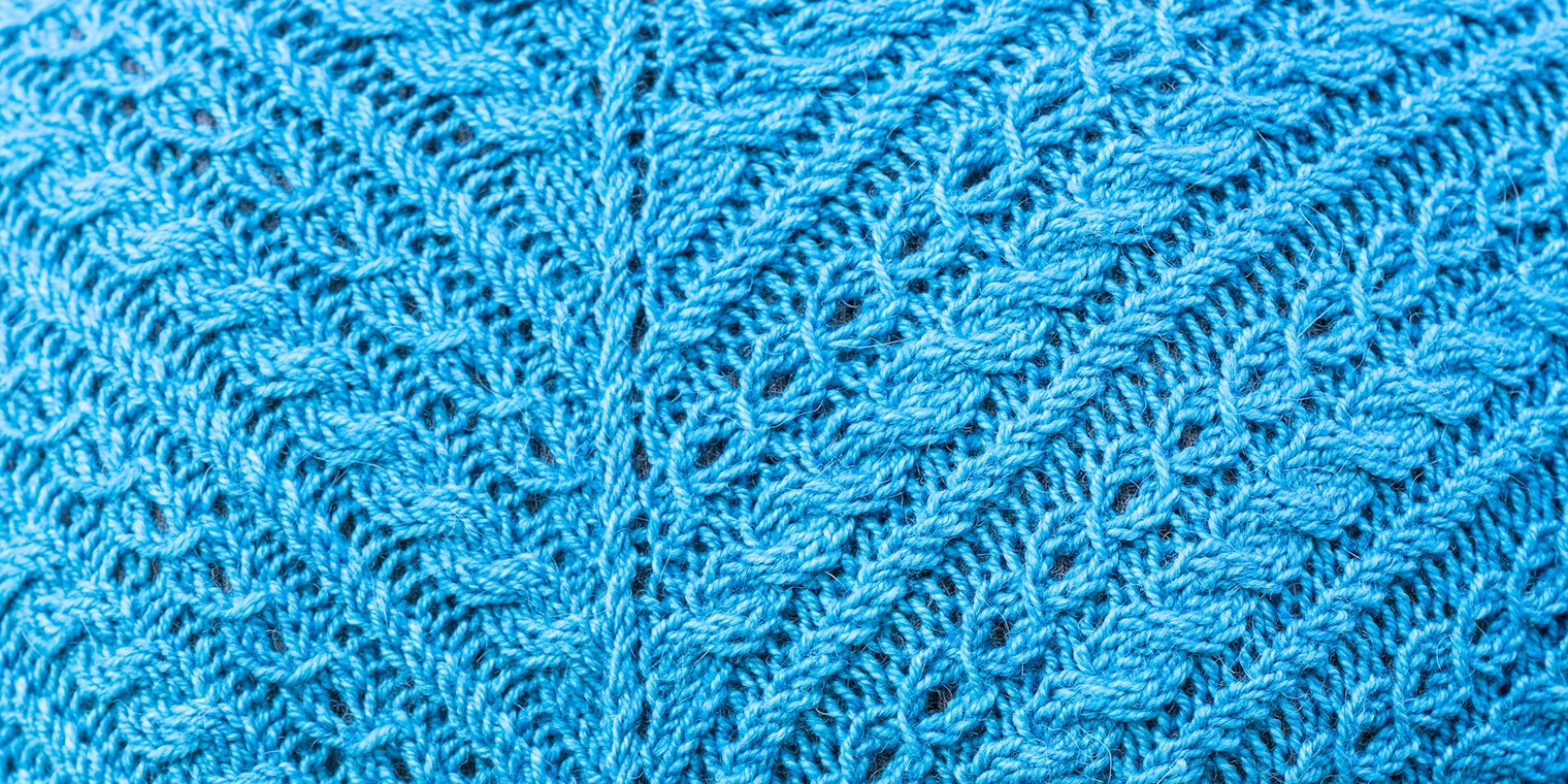 Blue-green cable-covered knitted fabric