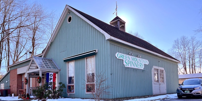 Light gray-green building with "Green Mountain Spinnery" sign on side