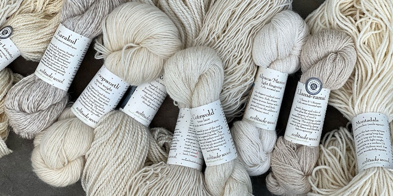 Hanks of natural colored yarn with Solitude Wool label