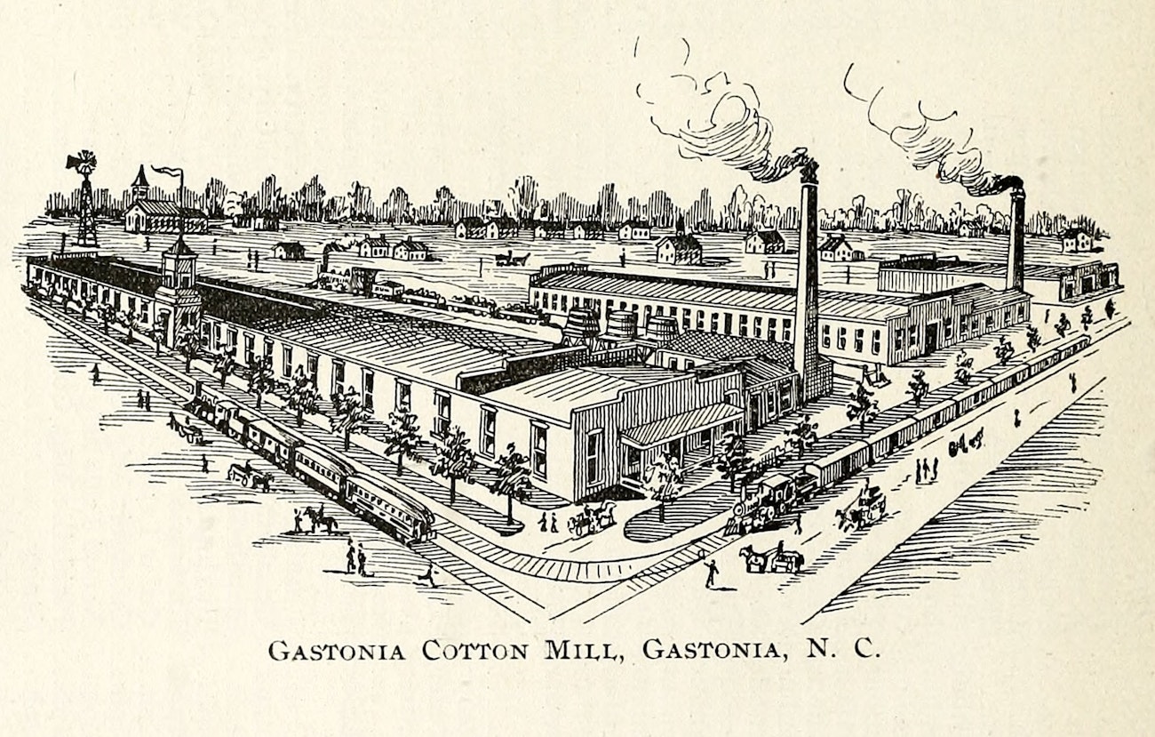 black-and-white historic drawing of mill, railroads, and surrounding town.