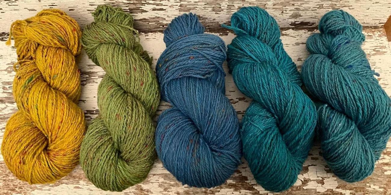 Yellow, green, and blue yarn with silk fiber blended in.