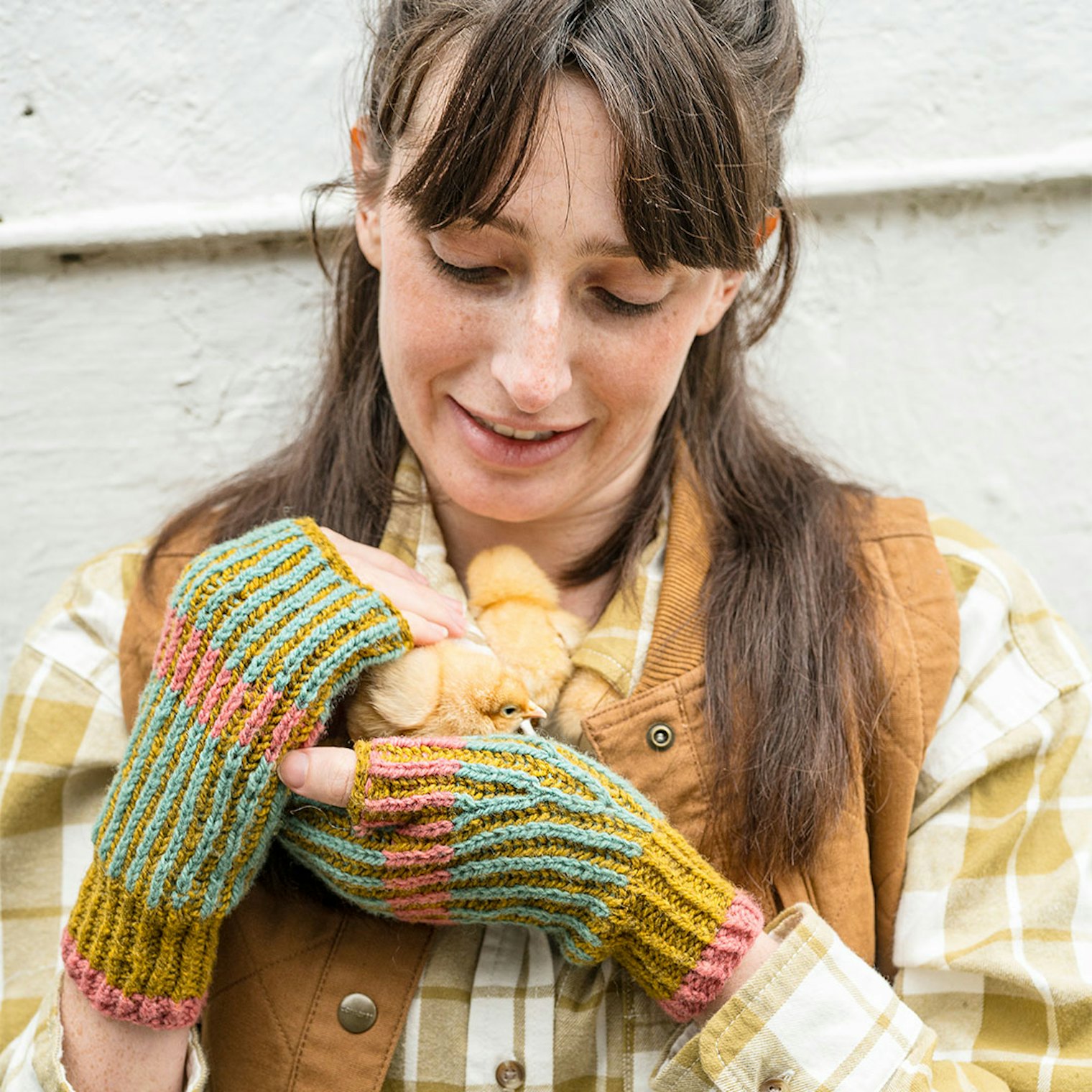 A plaid top and utility vest provide a background to the colorful Brooklyn Mitts.