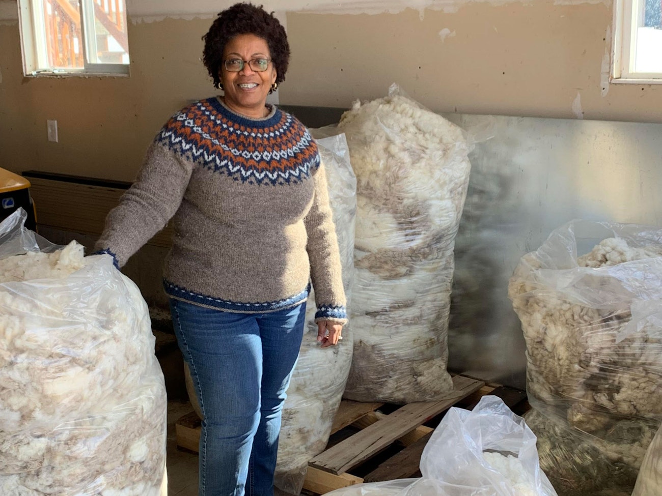 Farah Knudsen with bags of Polypay fleeces