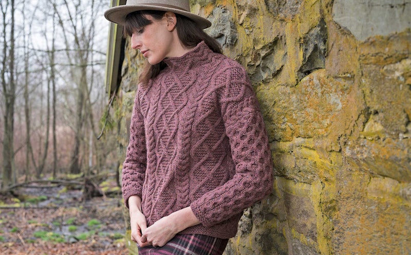 Plum-colored knitted cabled sweater