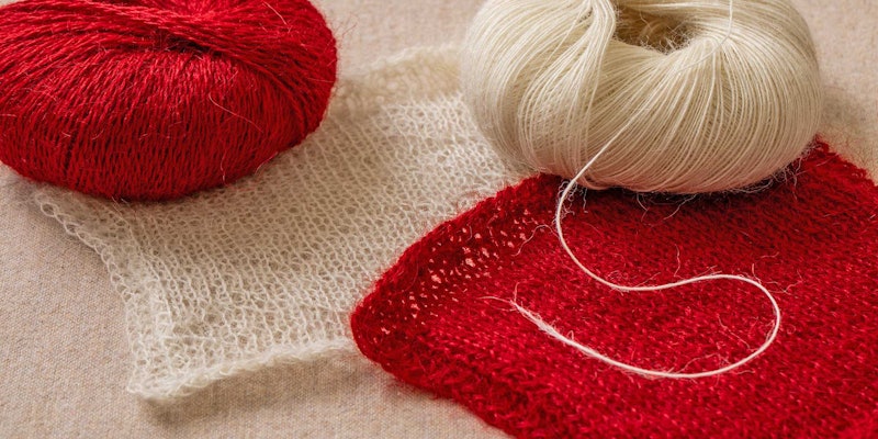 red and white yarns with knitted swatches
