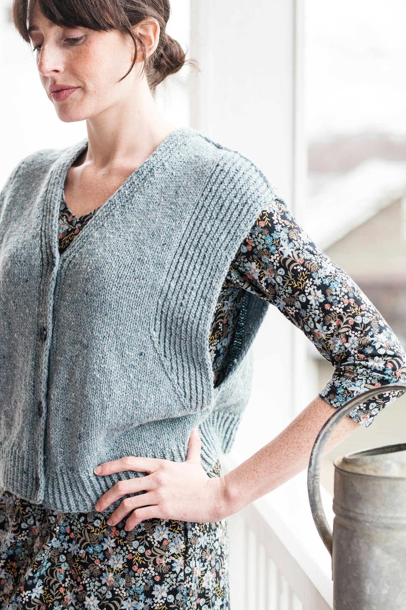 Woman in blue cardigan vest