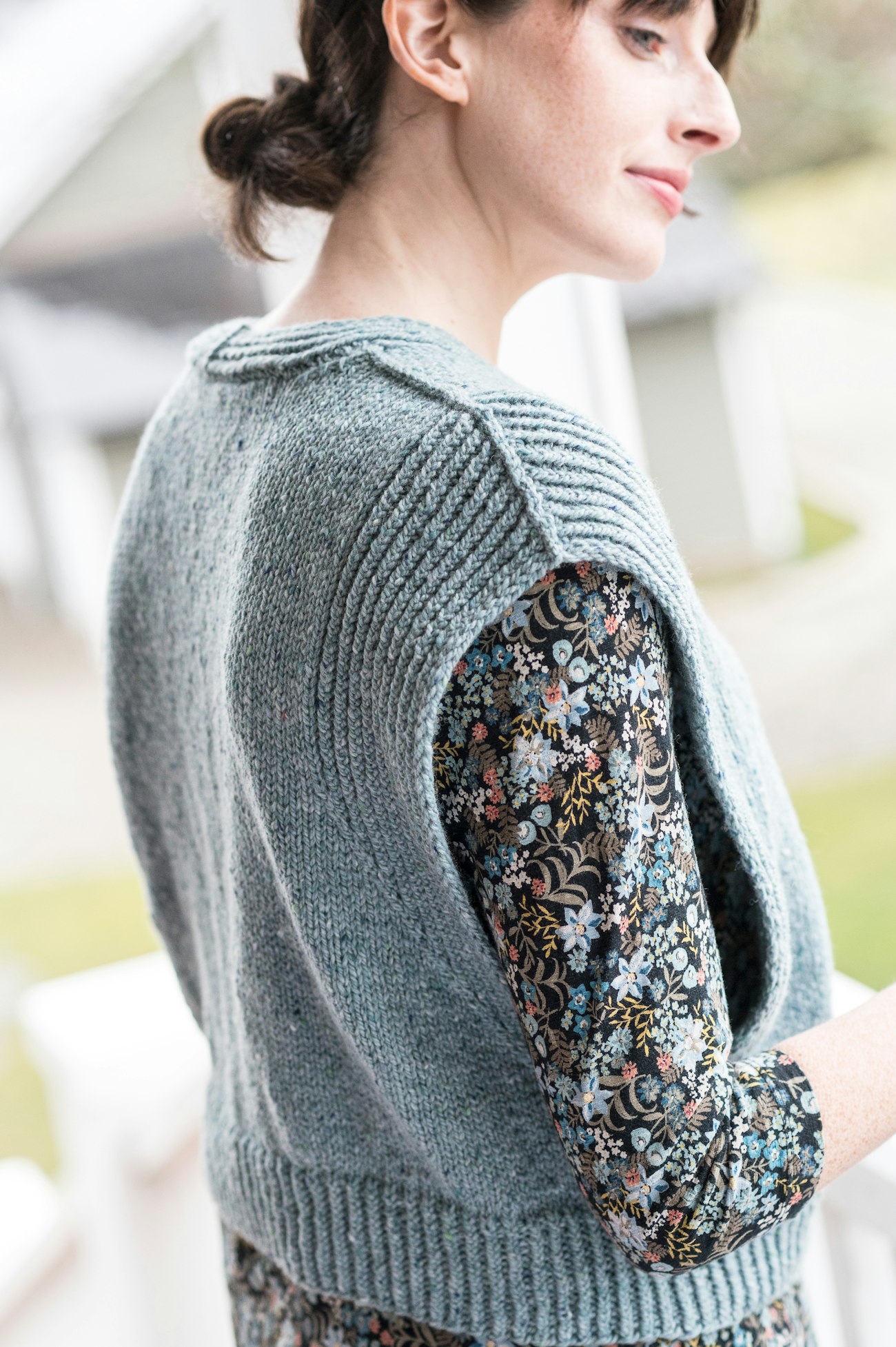 Woman in blue cardigan vest