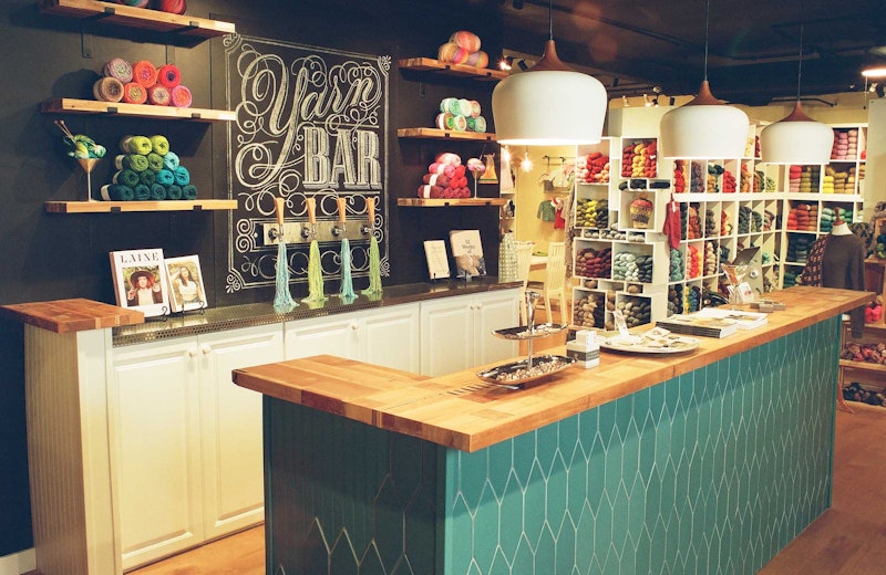 yarn shop with green counter and black wall