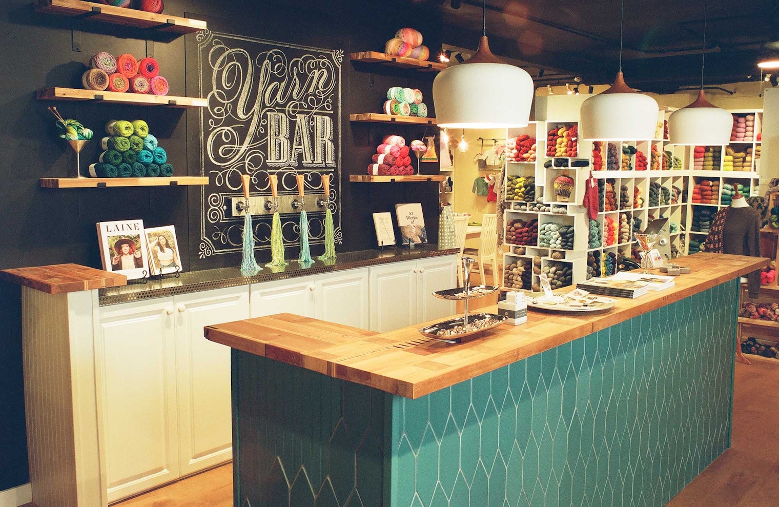 yarn shop with green counter and black wall