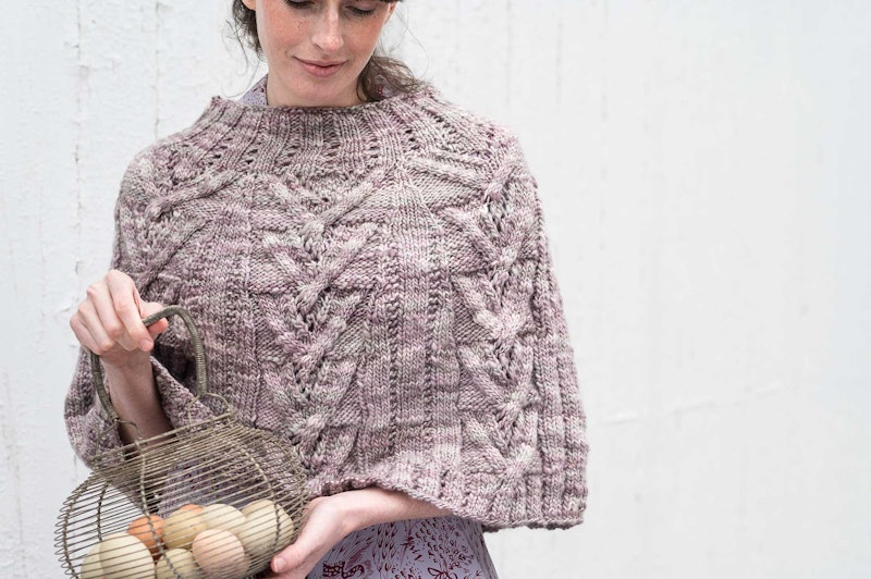 pink knitted poncho with cables