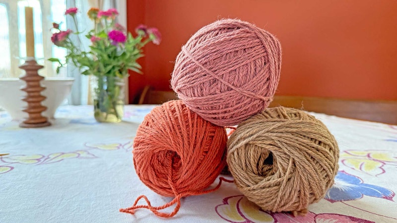 pink and tan balls of yarn