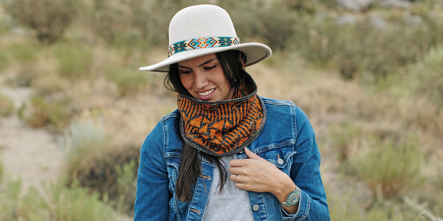 woman wearing white felt hat and orange knitted cowl
