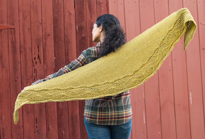 Woman in flannel shirt and gold handknitted shawl