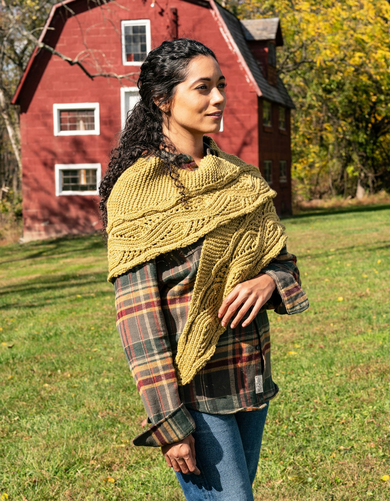 Woman in flannel shirt and gold handknitted shawl