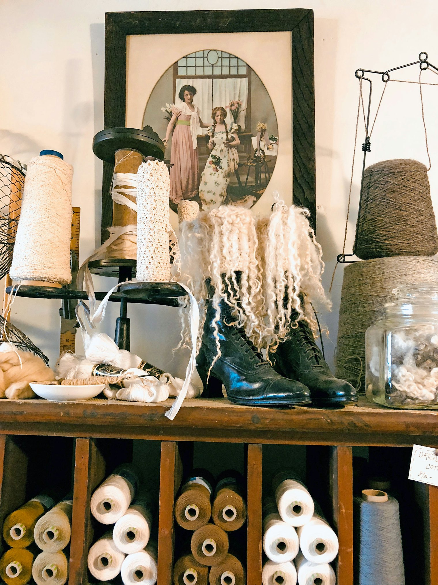 Yarn, wool locks, and other fiber goodness fills the shelves.