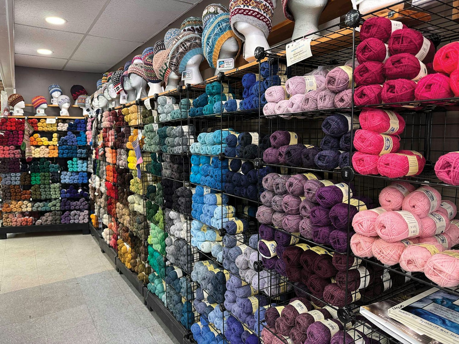 A wall of Shetland yarn in many different colors.