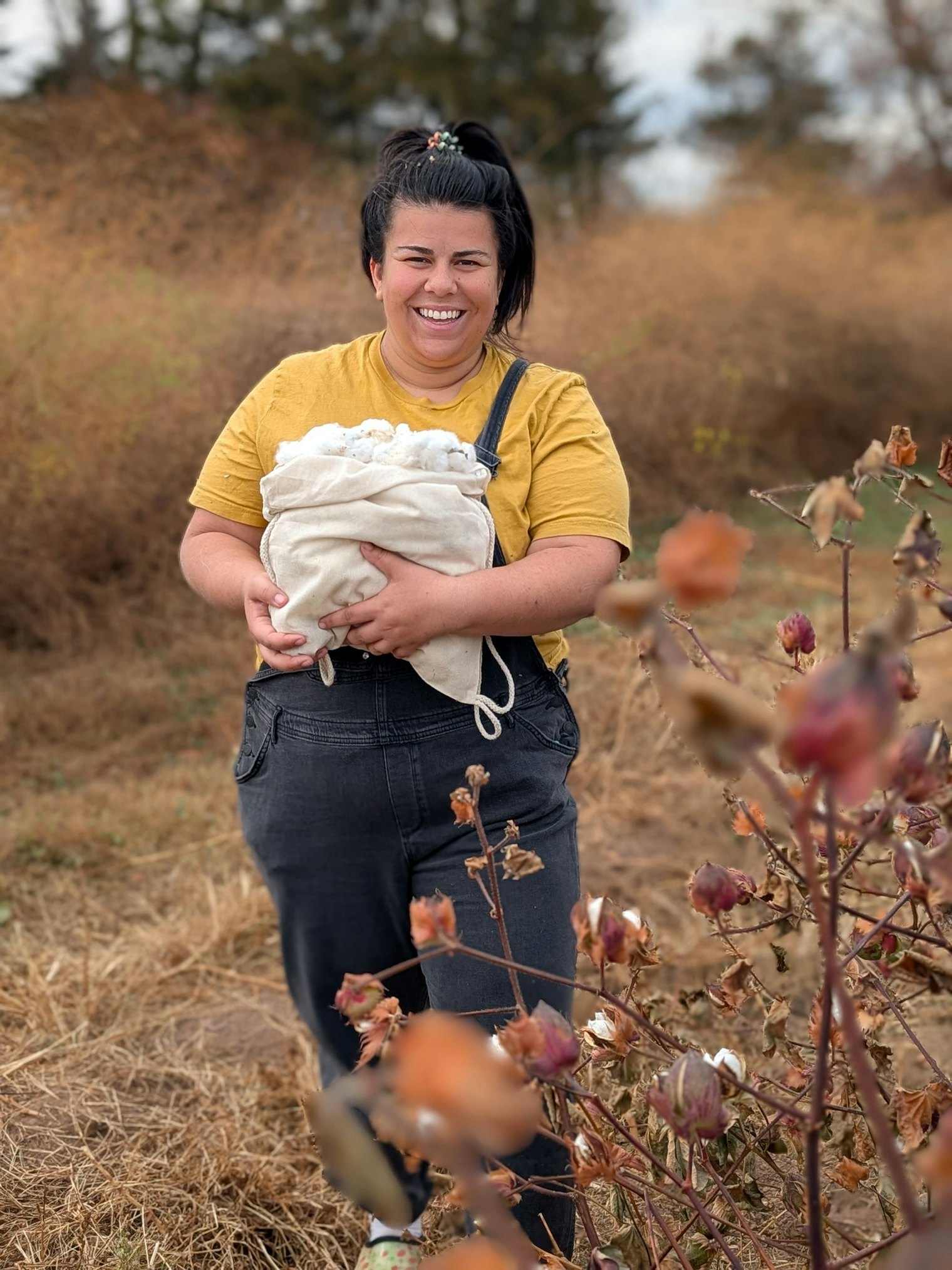 A member of the NJ Fibershed harvesting cotton.