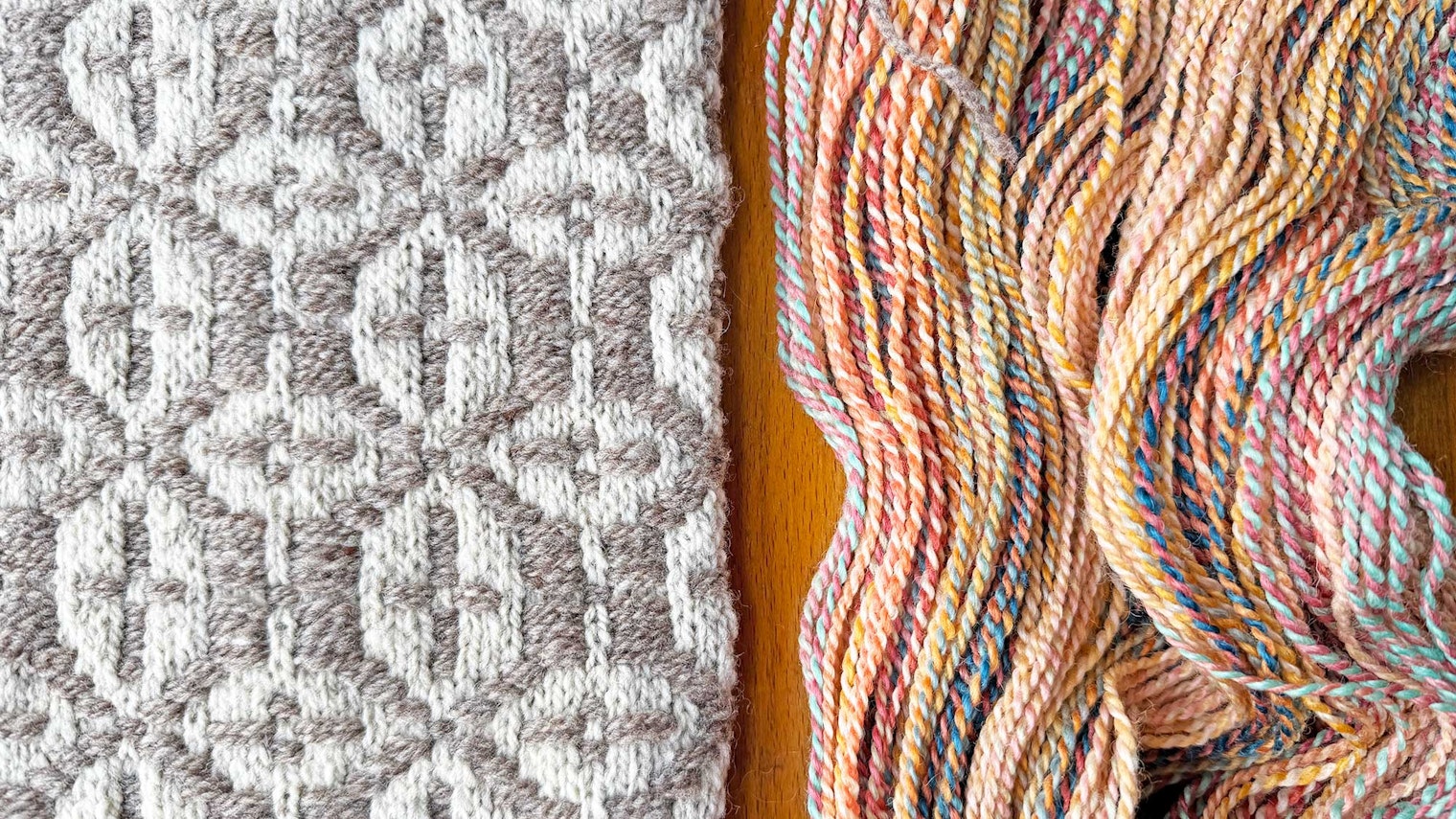 knitted tan and white swatch plus multi-colored skein of yarn
