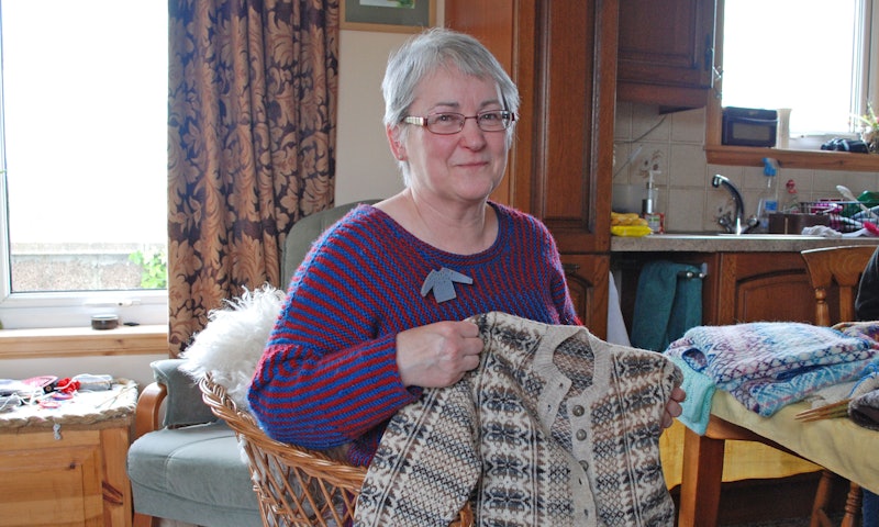 woman holding knitted sweater