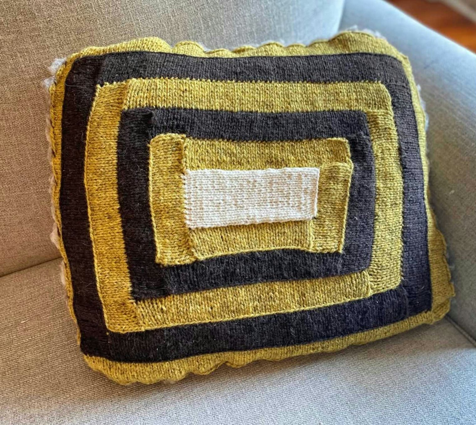 Erika knitted a couch cushion cover using the Rambouillet purchased during the yarn tasting event.