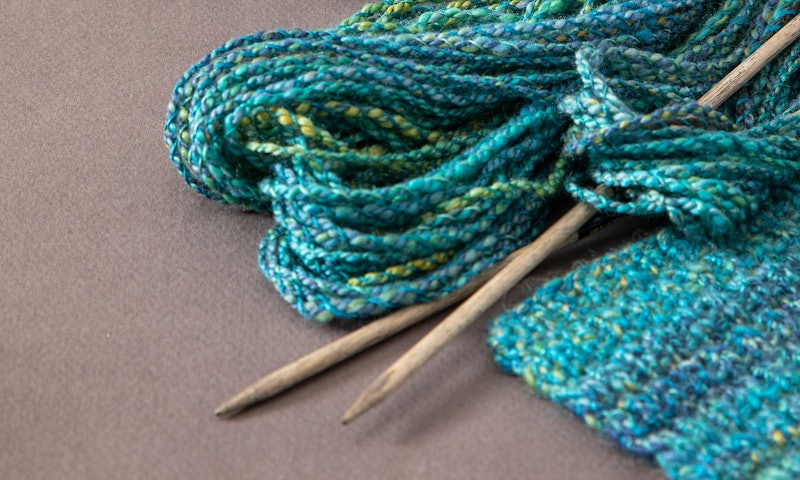 knitting needles and turquoise yarn