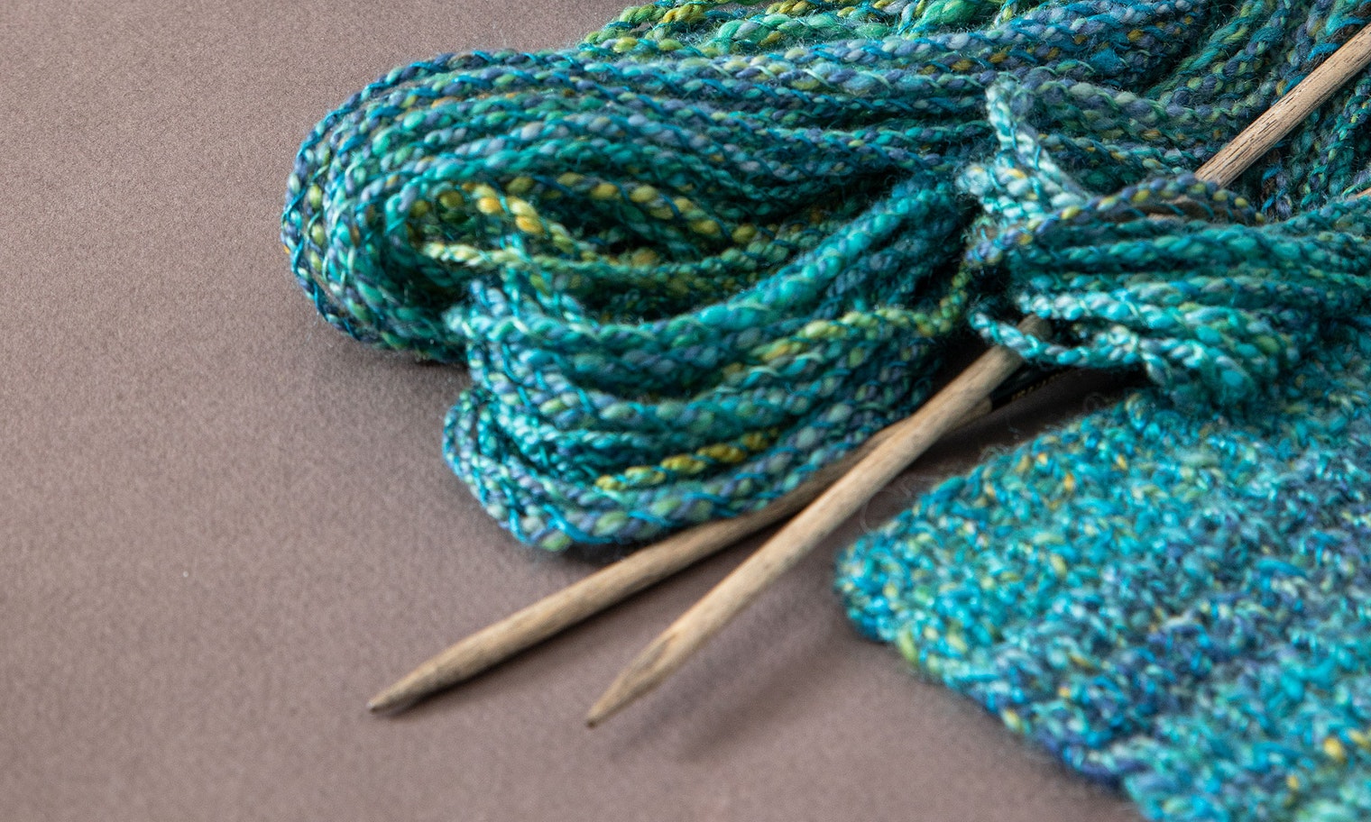 knitting needles and turquoise yarn