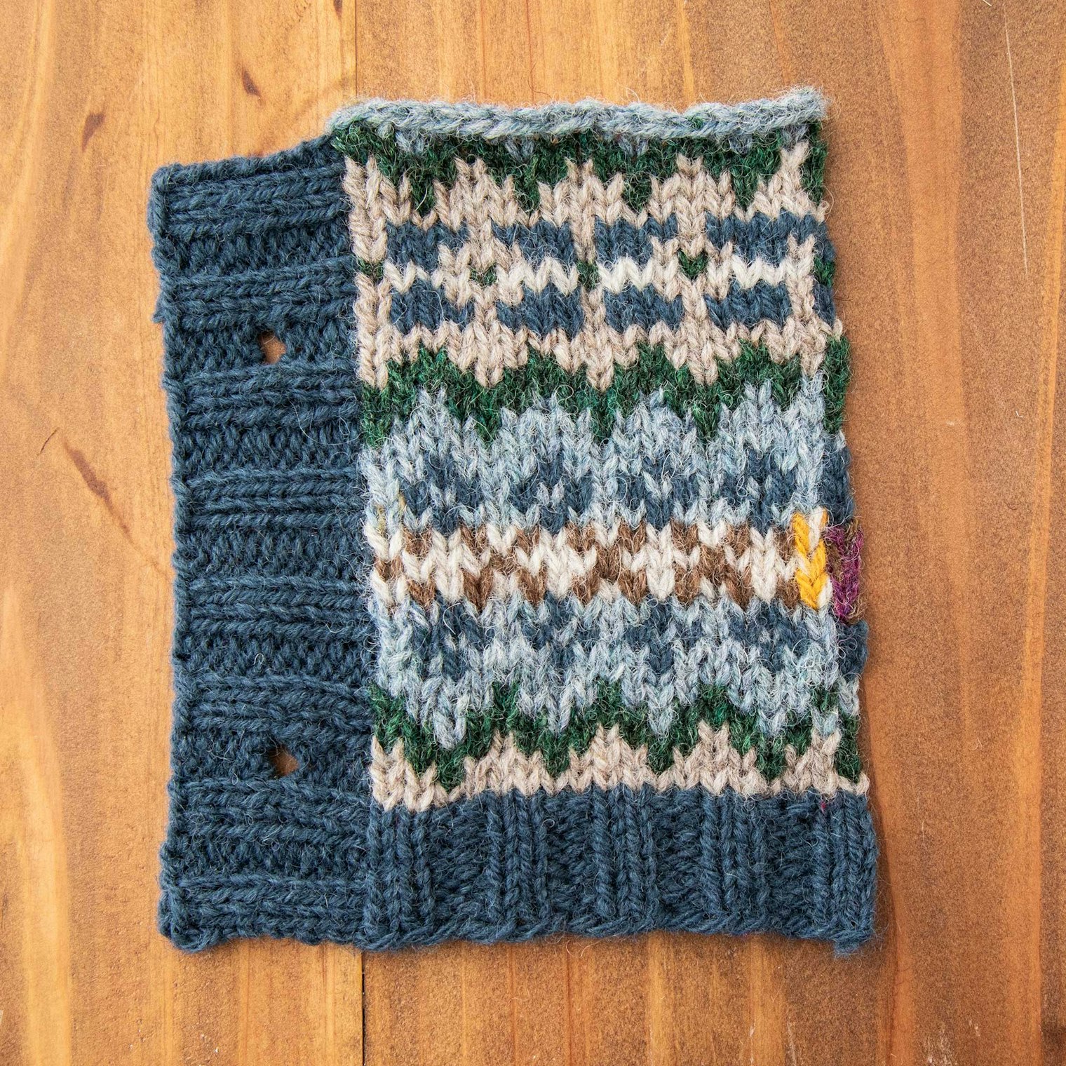 Stonehenge, Mooskit, Conifer, Highland Mist, Moorit, and Pebble. Sandi used this swatch to sample the front-edge ribbing. After the swatch was cut from its neighbors, she picked up and knit the vertical rib.