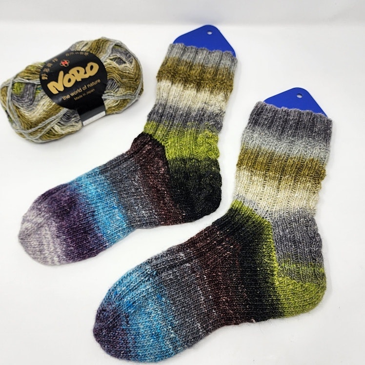 Gabi showing her finished Farmers Favorite Socks.
