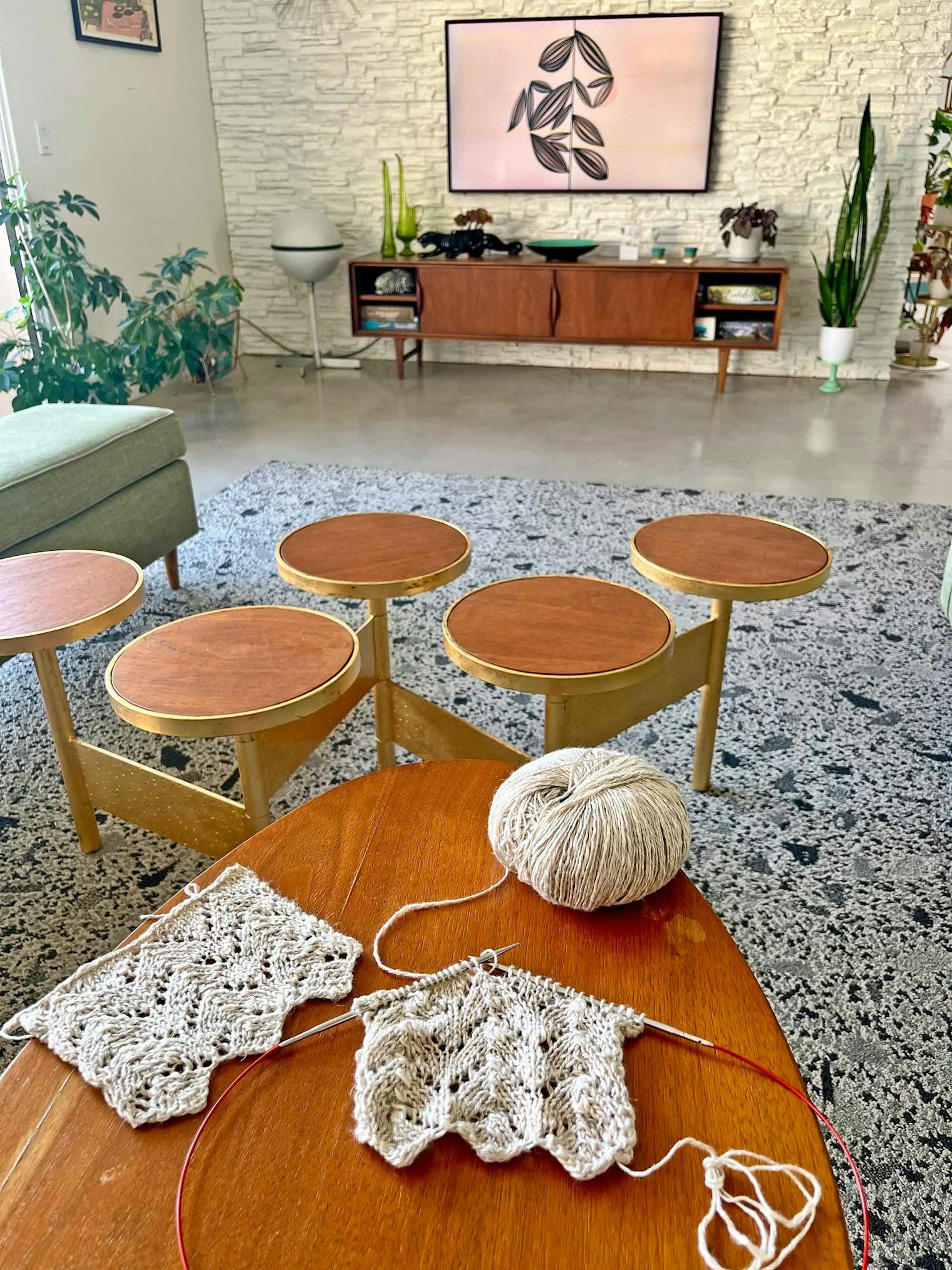 Knitting in her living room, Lindsay can tune in to a favorite show or look out at the pool.