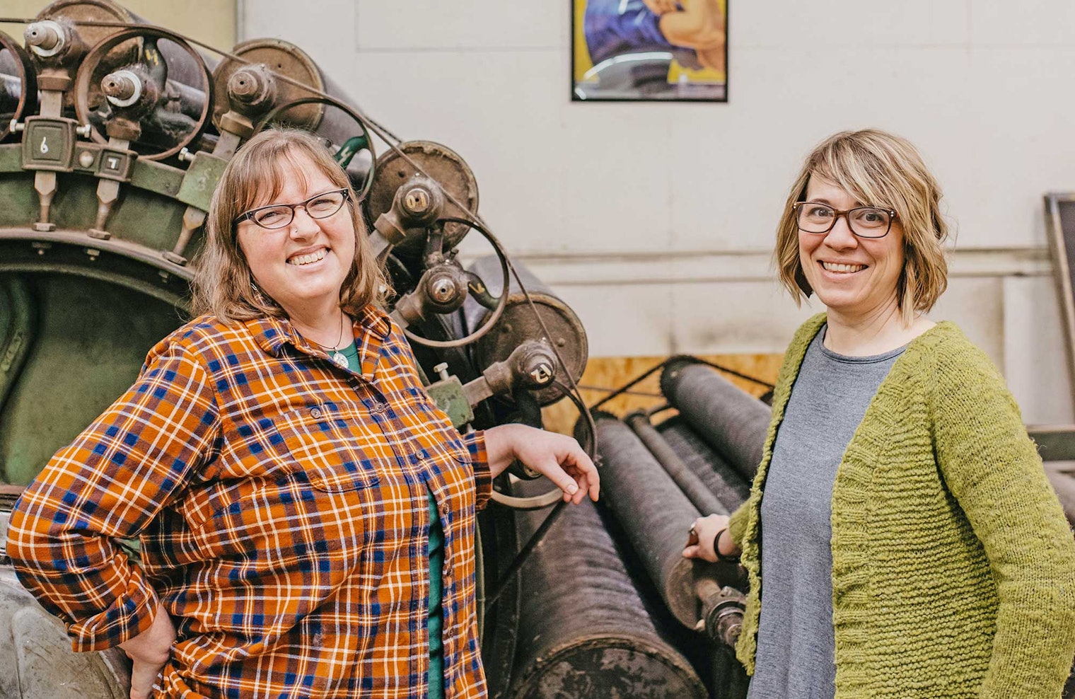 Owners Anna and Jess stand next to their century-old carder, Rosie. Photo by Kayti Clayton, Luna + Lion Co.
