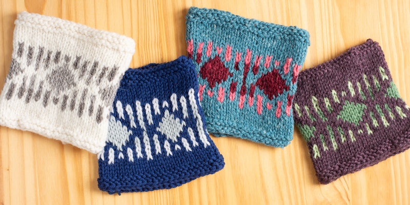 Four knitted swatches against a wooden background.