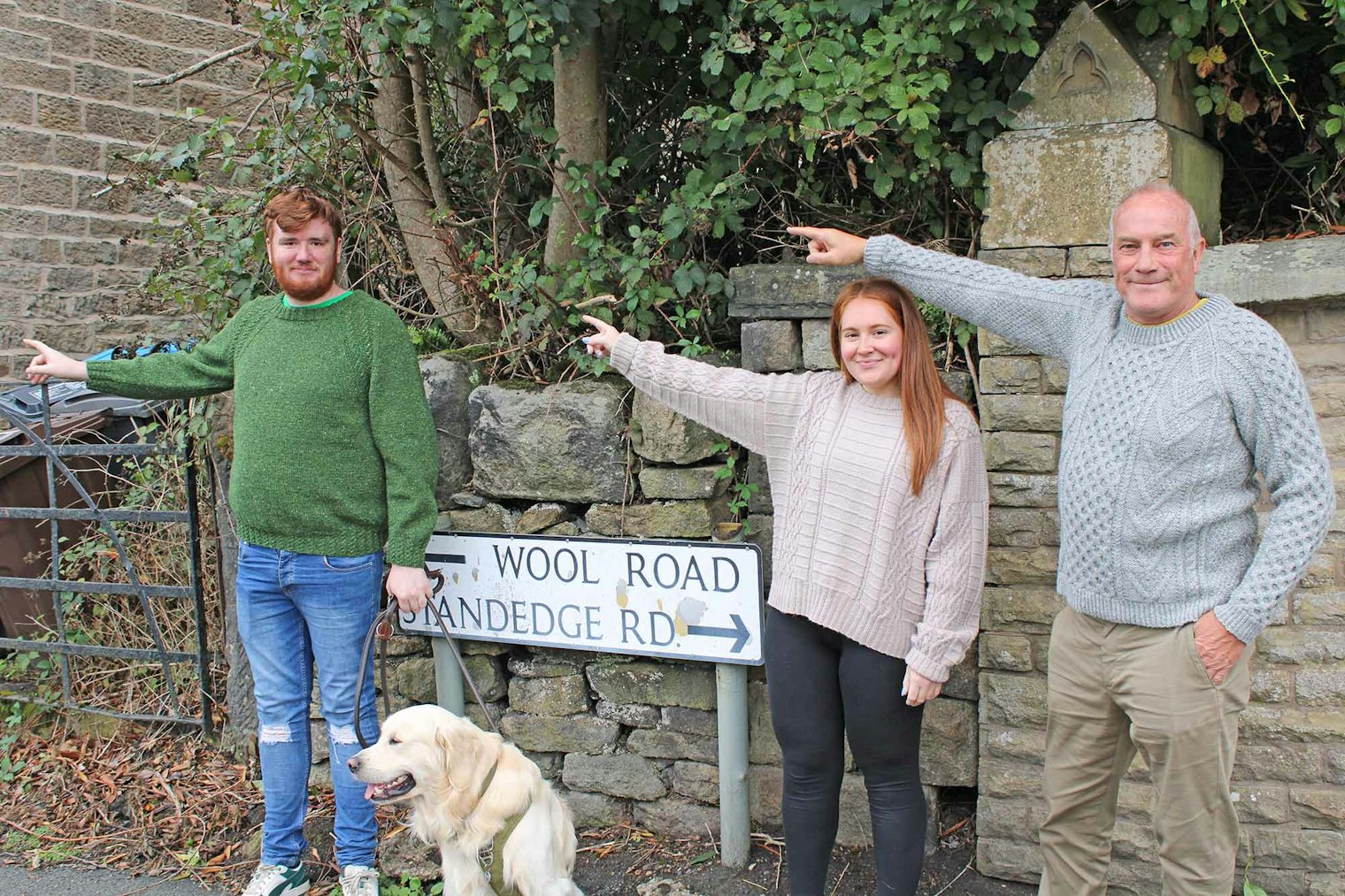 The team points the way. Shown left to right: Owen, Claire, and Roger.