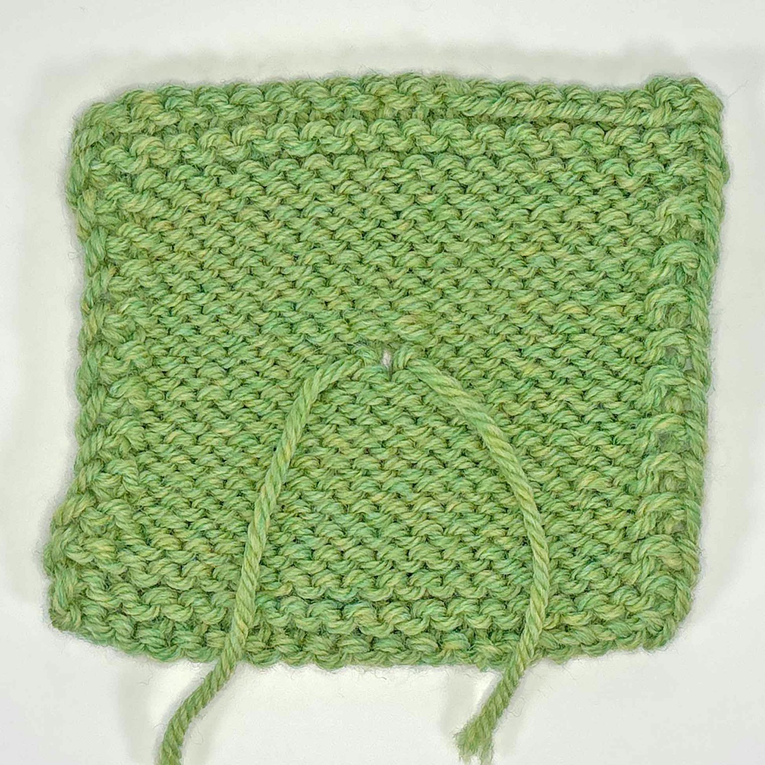 Wrong side of knitted sample, showing the tails from the old and new yarn.