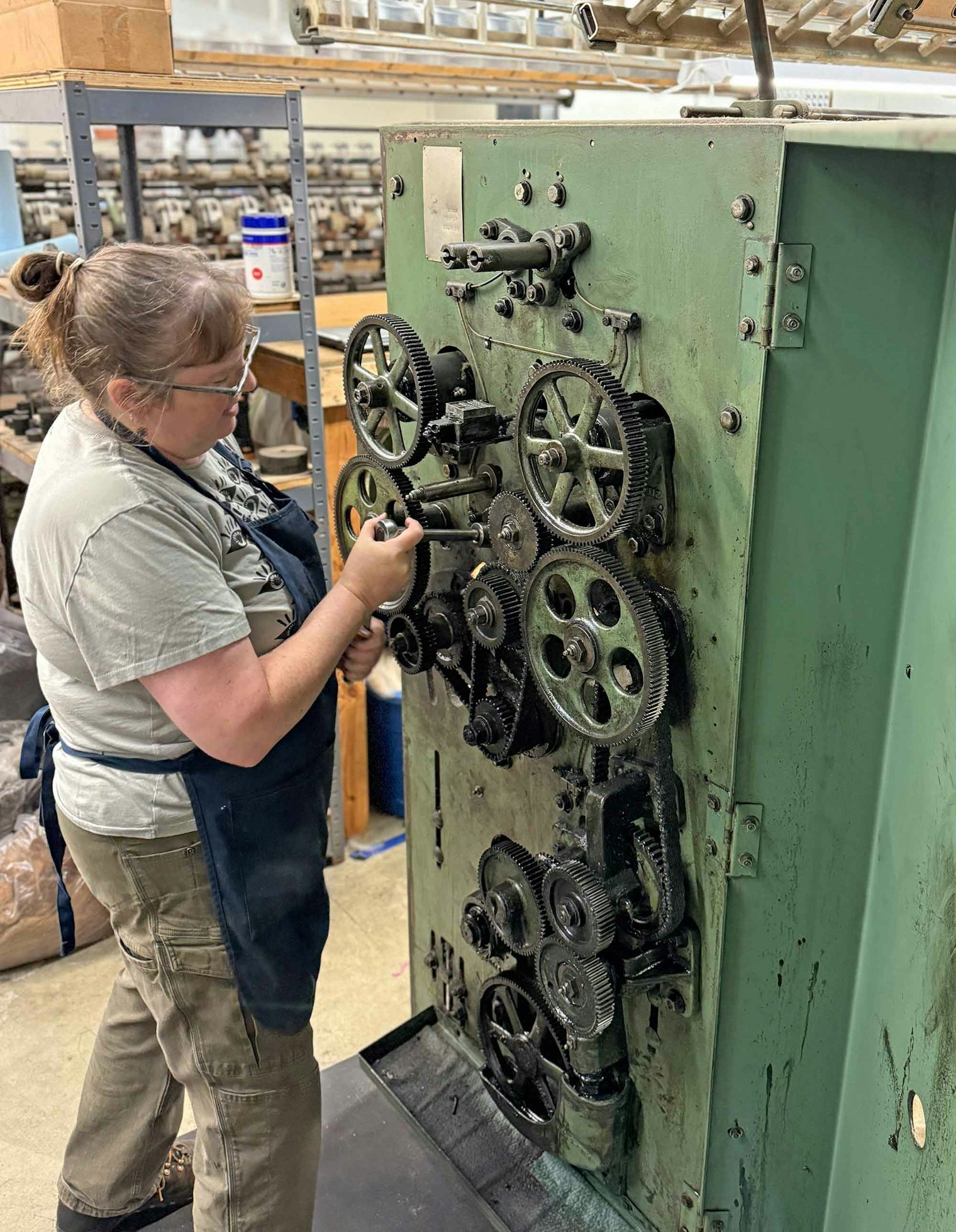 Anna adjusts the spinner gears for the right amount of twist.