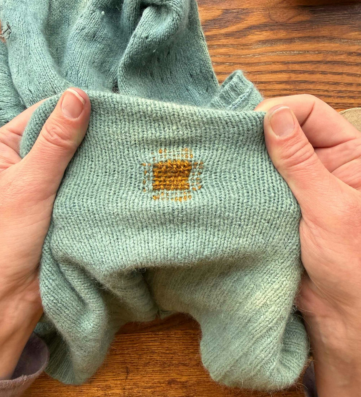 Kate finds the woven mends that include a few stitches beyond the woven patch have less puckering when the knitted fabric is pulled.