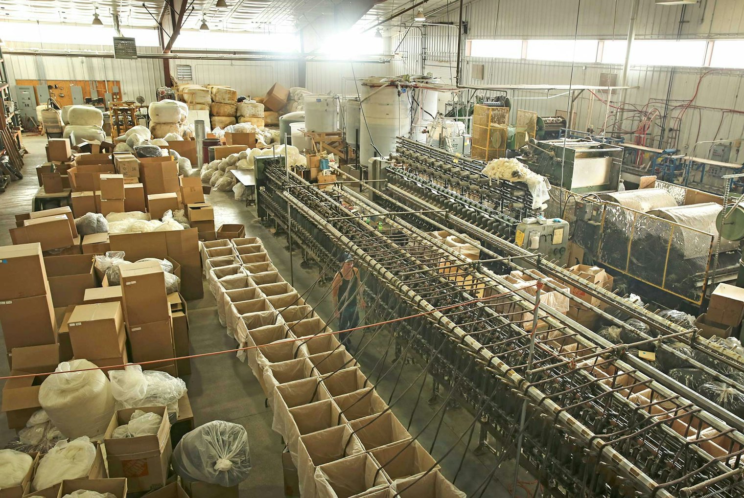 Sandi Rosner’s Northern Exposure Pullover celebrates Suffolk, the most common sheep in the United States but one whose wool is rarely used. She profiles the yarn’s manufacturer, Mountain Meadow Wool, which is dedicated to preserving wool in the West by spinning this wool into usable yarn. Here‘s a view of the production floor from the mezzanine level. Photo courtesy of Mountain Meadow Wool