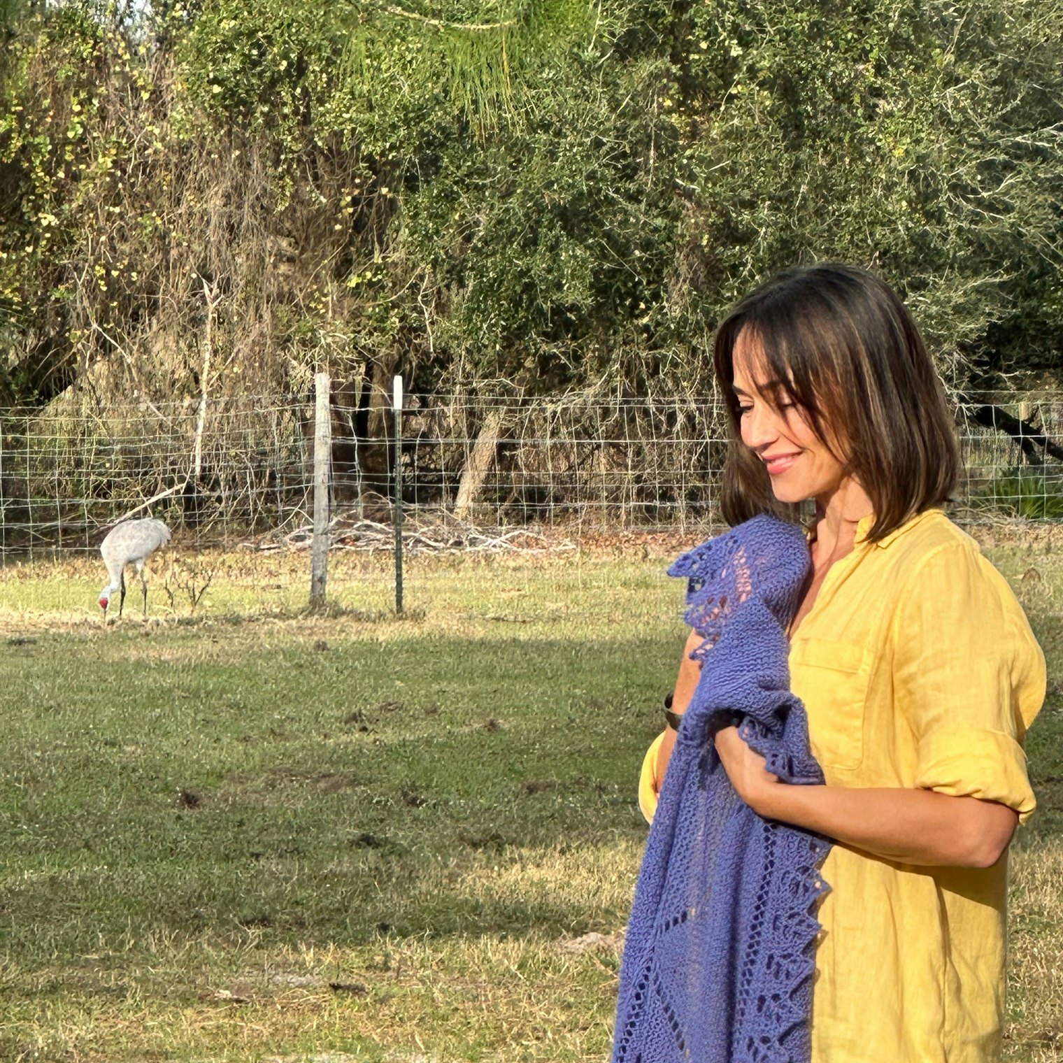 Dawn, one of our models at the shoot, holds a project while being serenaded by sandhill cranes.